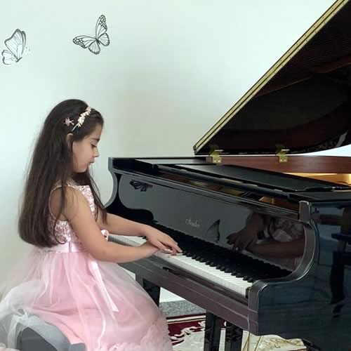Young girl playing piano