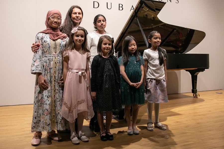 Marina Zamfir with her students who attends her piano classes in Duabi